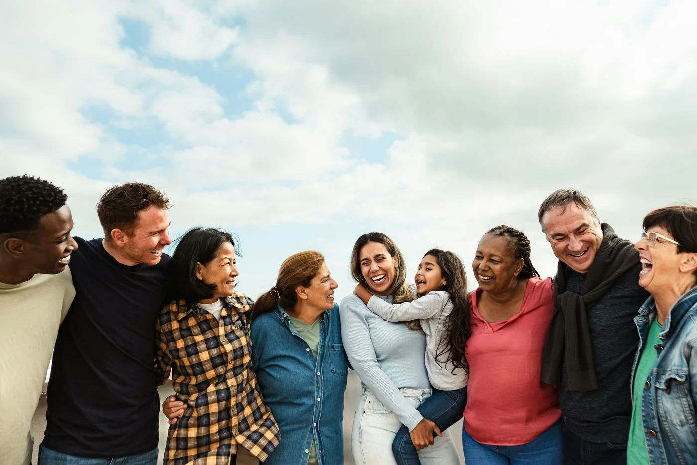 A group of friends standing together outdoors.